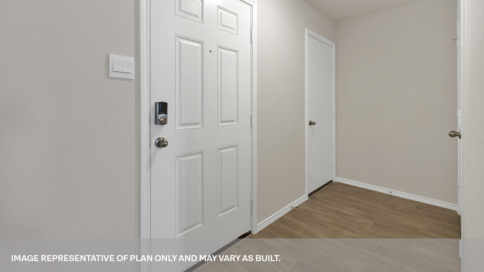 Entry hallway leading to the kitchen with kitchen island.