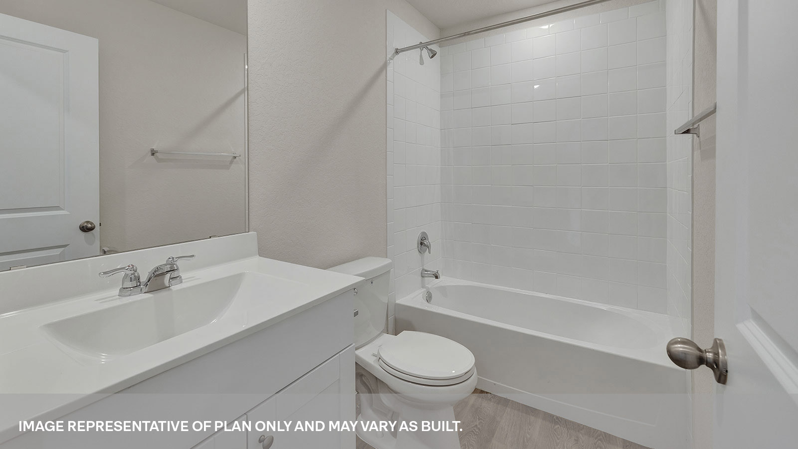 Hall bathroom with tub with tile surround, toilet, and single-vanity sink.