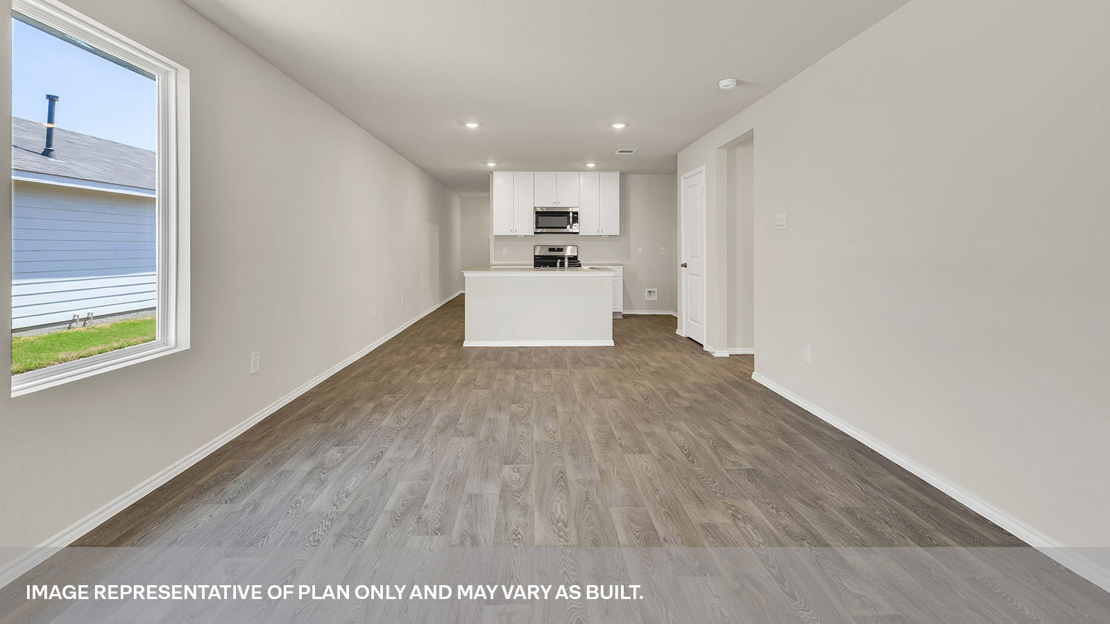 Dining room with vinyl flooring and opening to the living room.