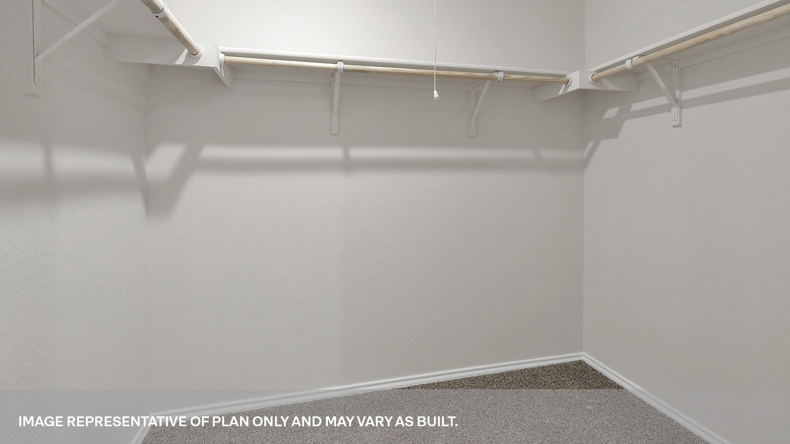 Main bedroom closet with carpeting and wooden shelving.