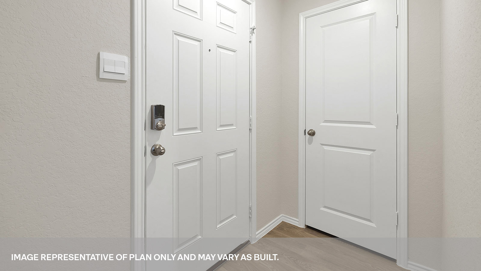 Entryway with vinyl flooring and front door.