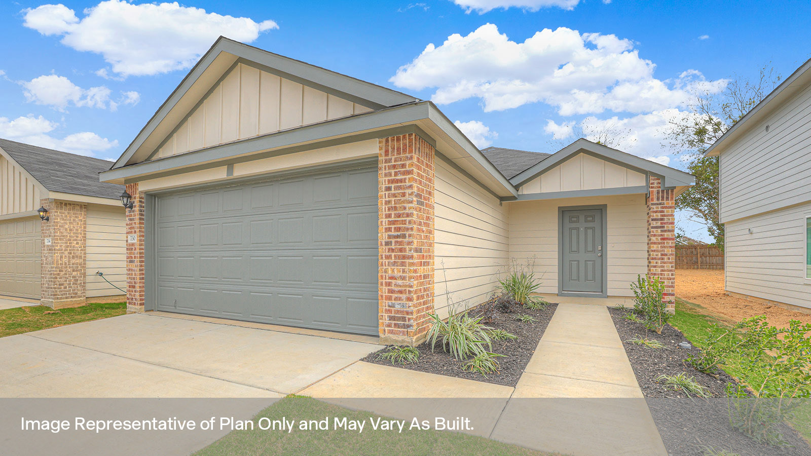 Two car garage, siding and a wrap around sidewalk to the front entry