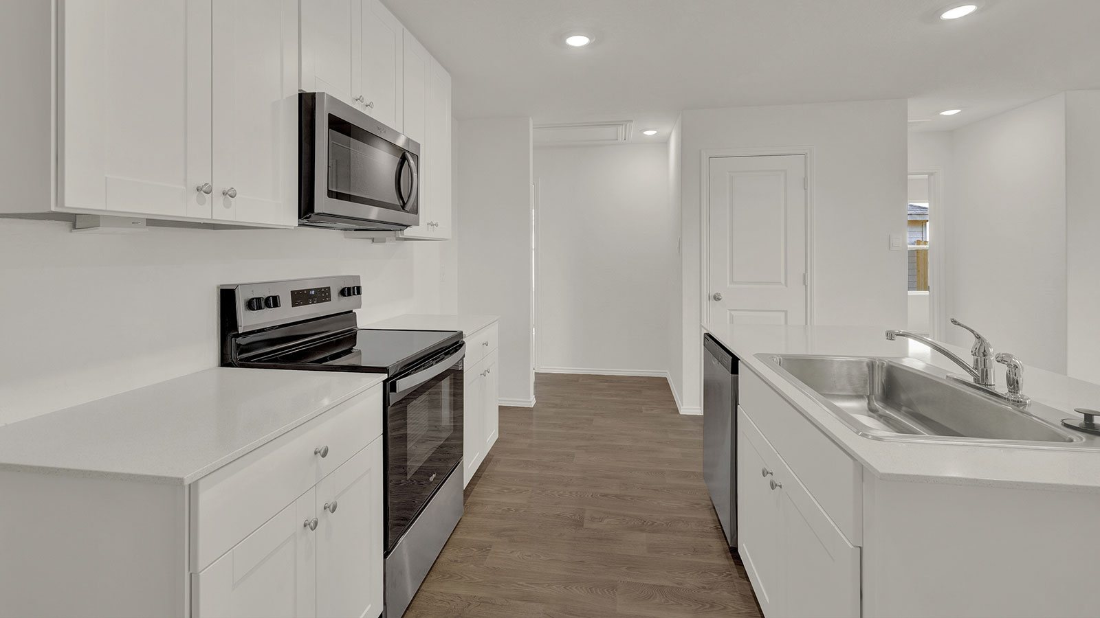 Kitchen with quartz countertops and stainless-steel appliances.