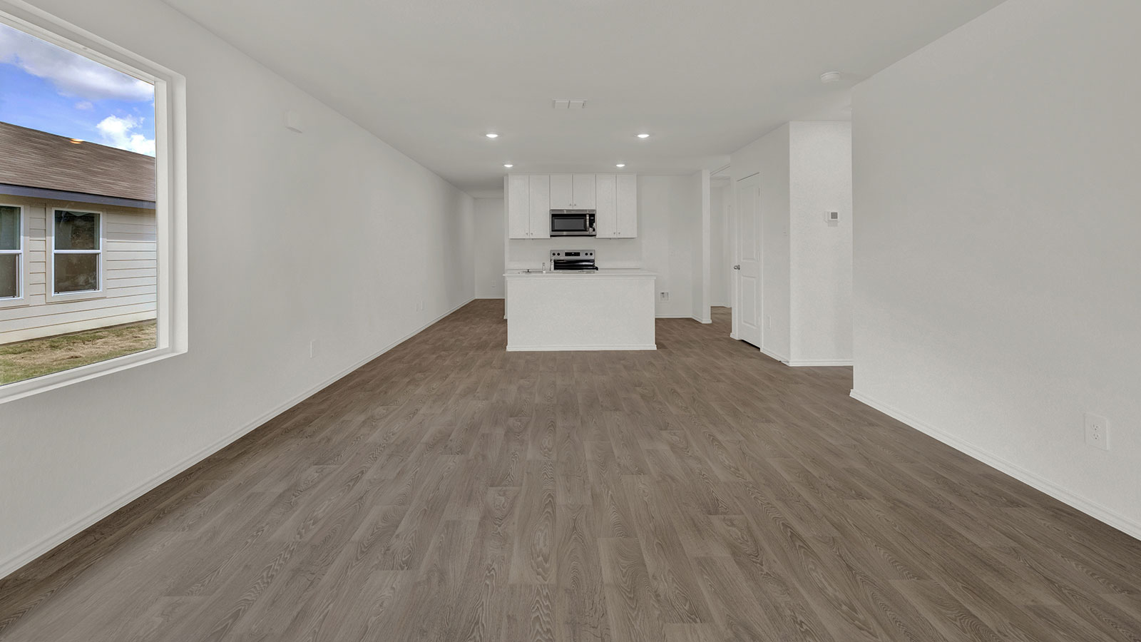 Living room opening to the dining room and kitchen.