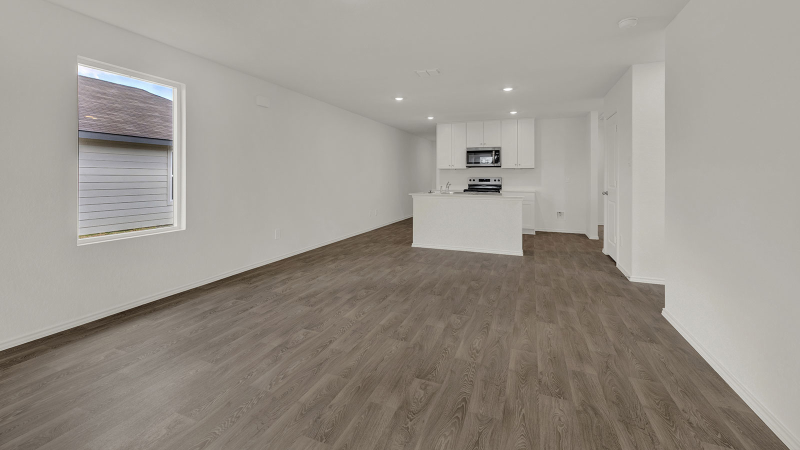 Living room opening to the dining room and kitchen.