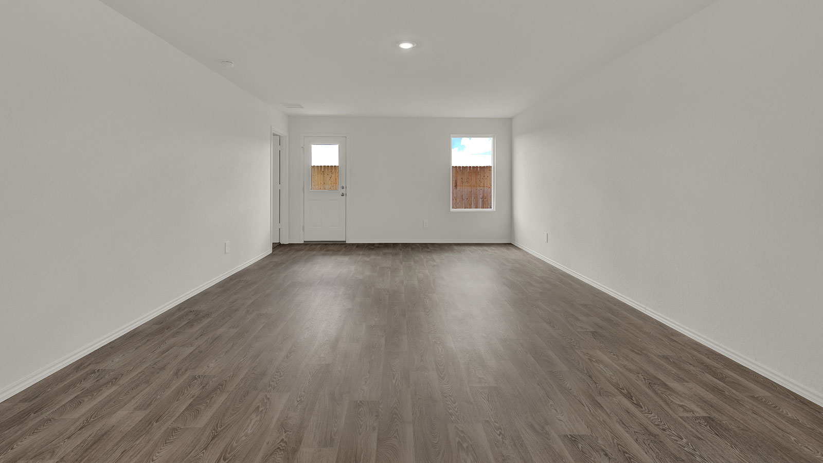 Living room with vinyl flooring and one window.