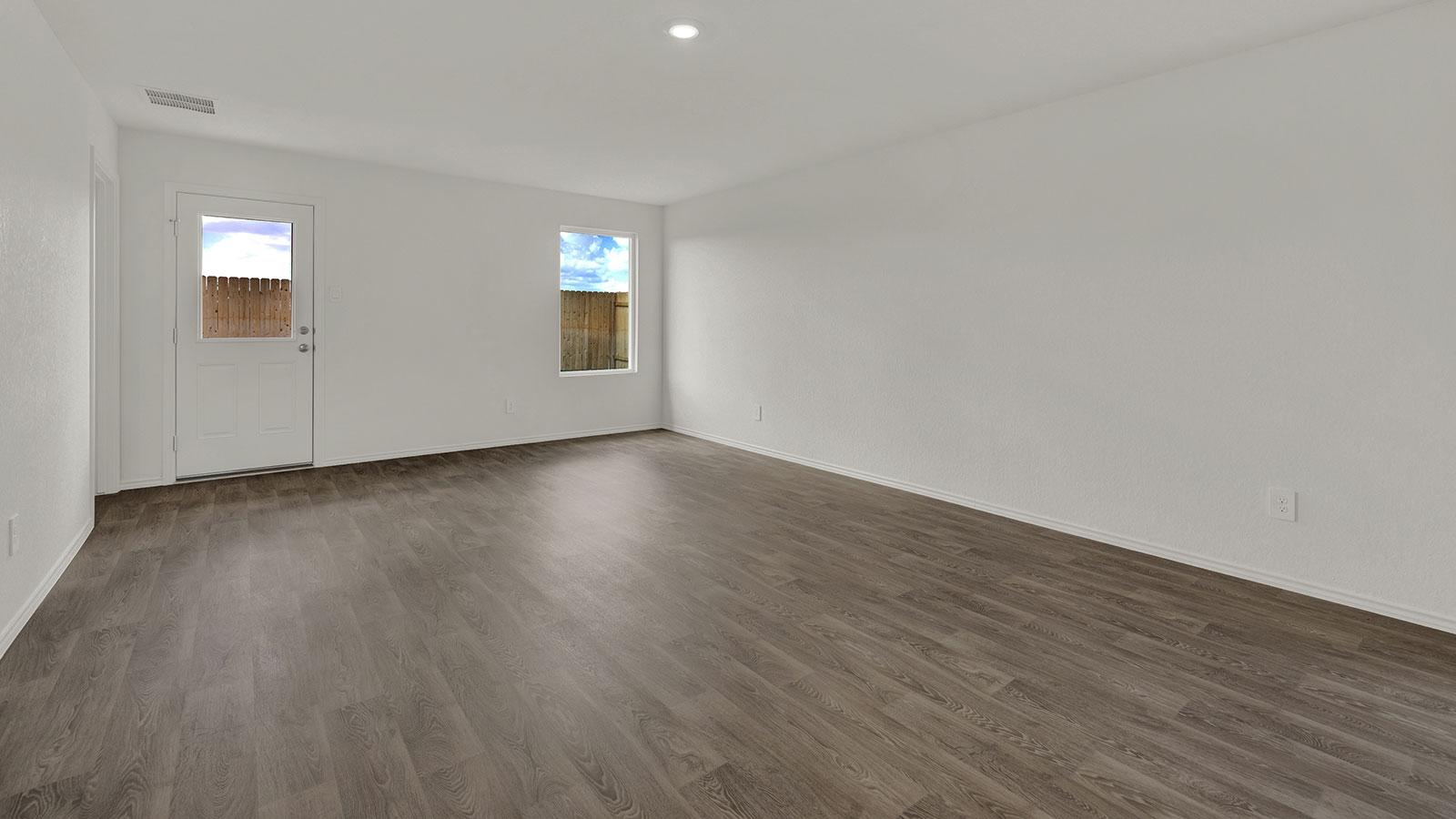 Living room with vinyl flooring and one window.