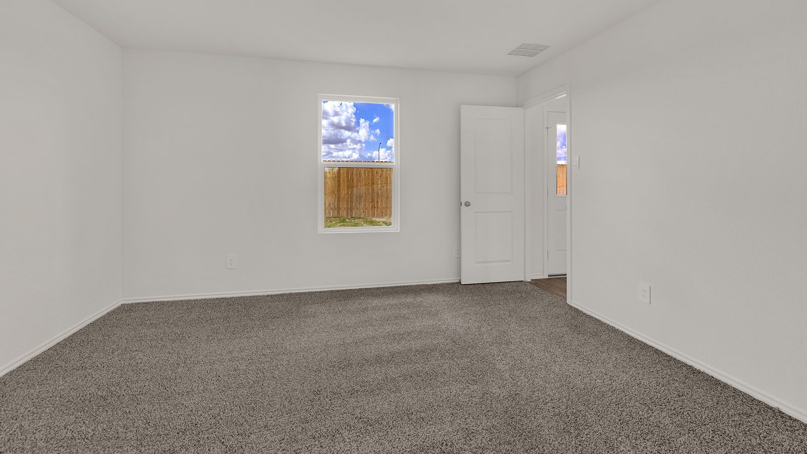 Main bedroom with carpeting and one window.