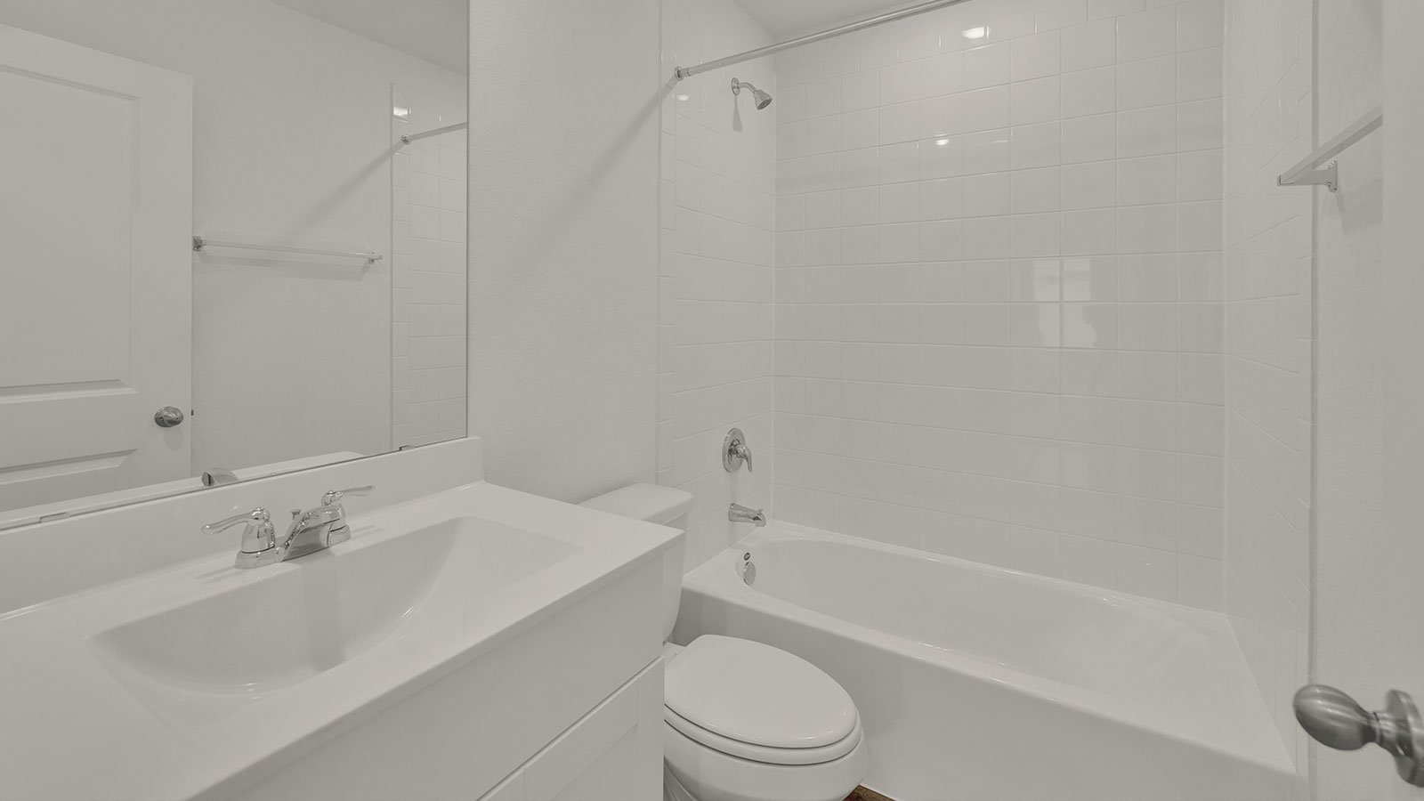 Hall bathroom with single-sink vanity, toilet, and tub.