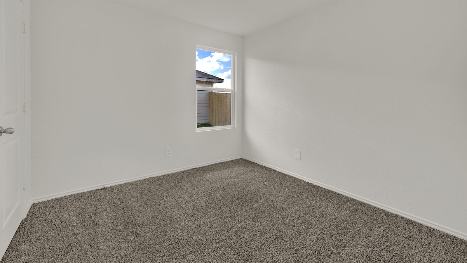 Bedroom with carpeting and one window.
