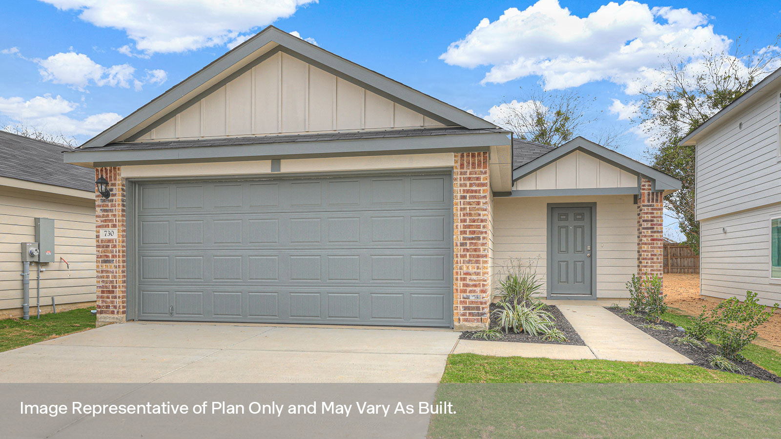 two car garage, siding and a wrap around sidewalk to the front entry