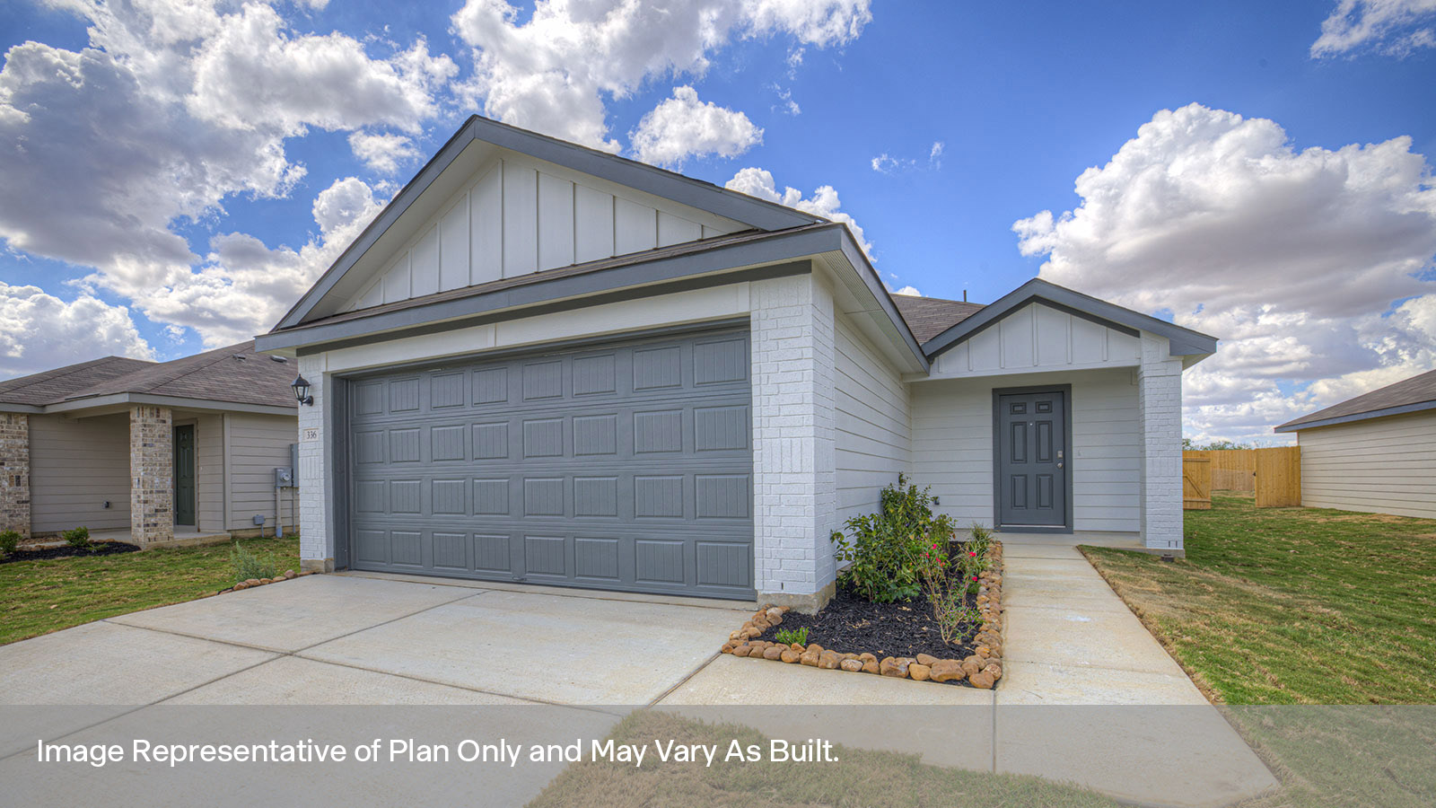 two car garage, siding and a wrap around sidewalk to the front entry