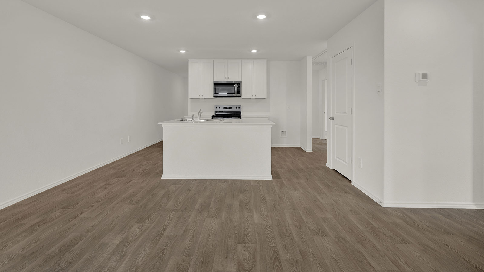 Kitchen with kitchen island and white cabinets.