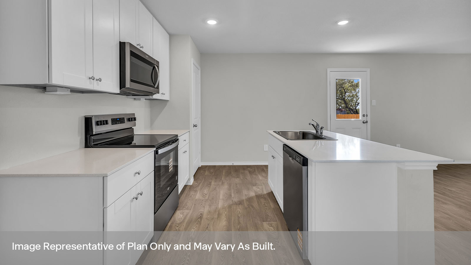 Kitchen view of white cabinets, quartz counter tops and stainless appliances