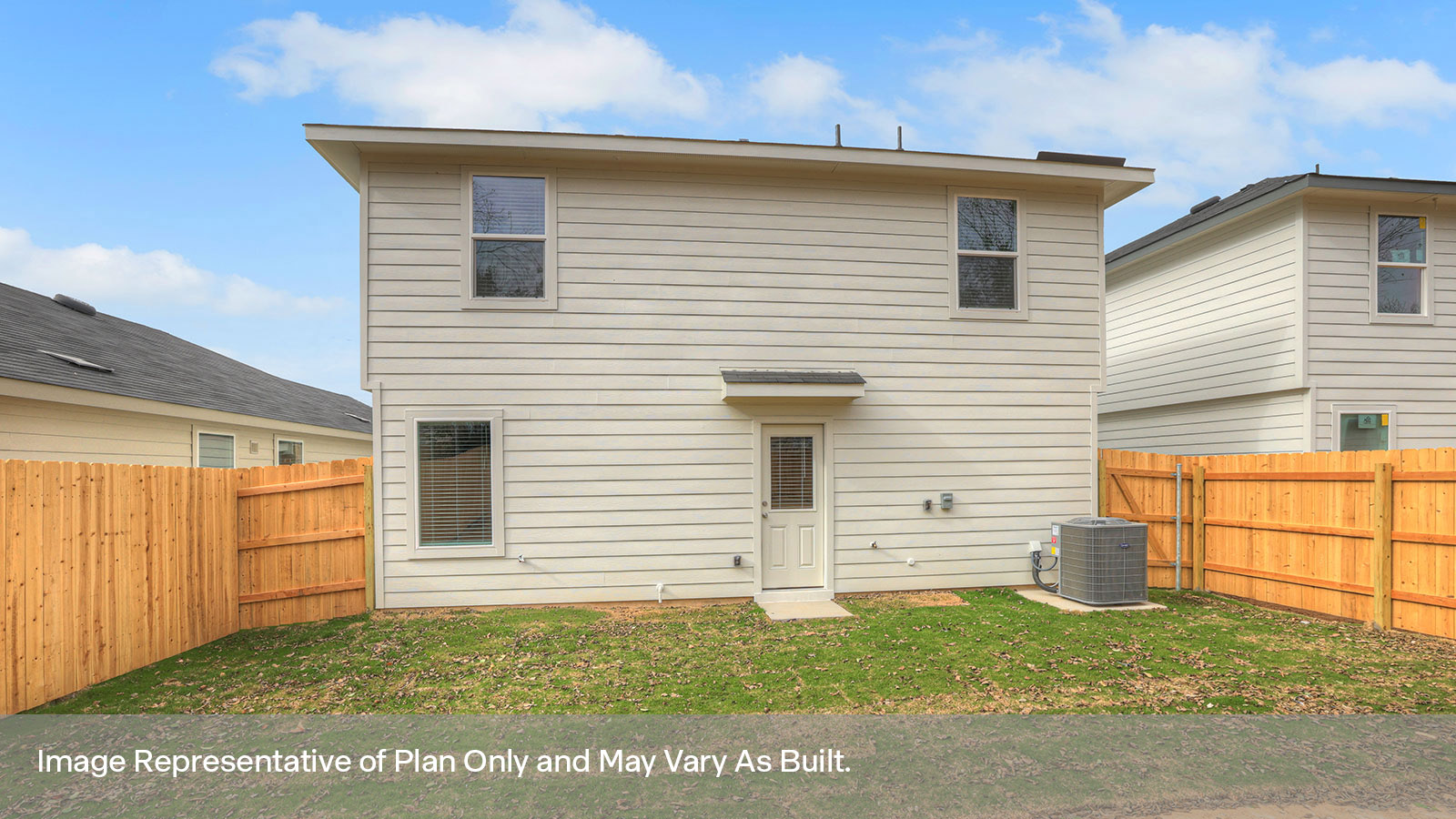 Rear exterior, fully sodded yard and a 6' privacy fence