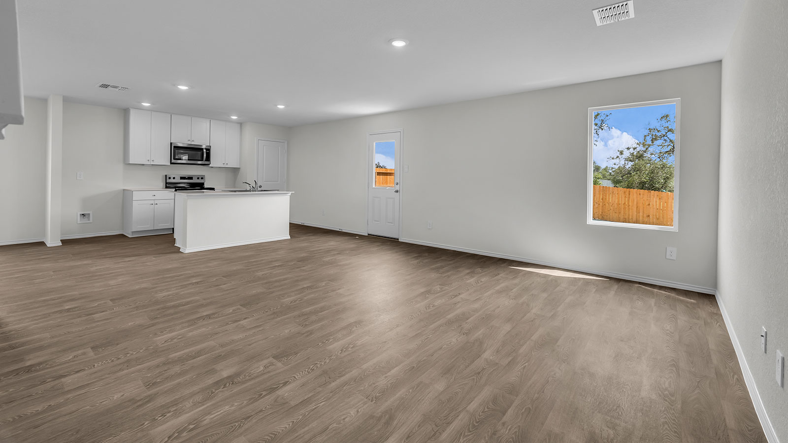 Living room with vinyl flooring, one window, and a half lite exterior door.