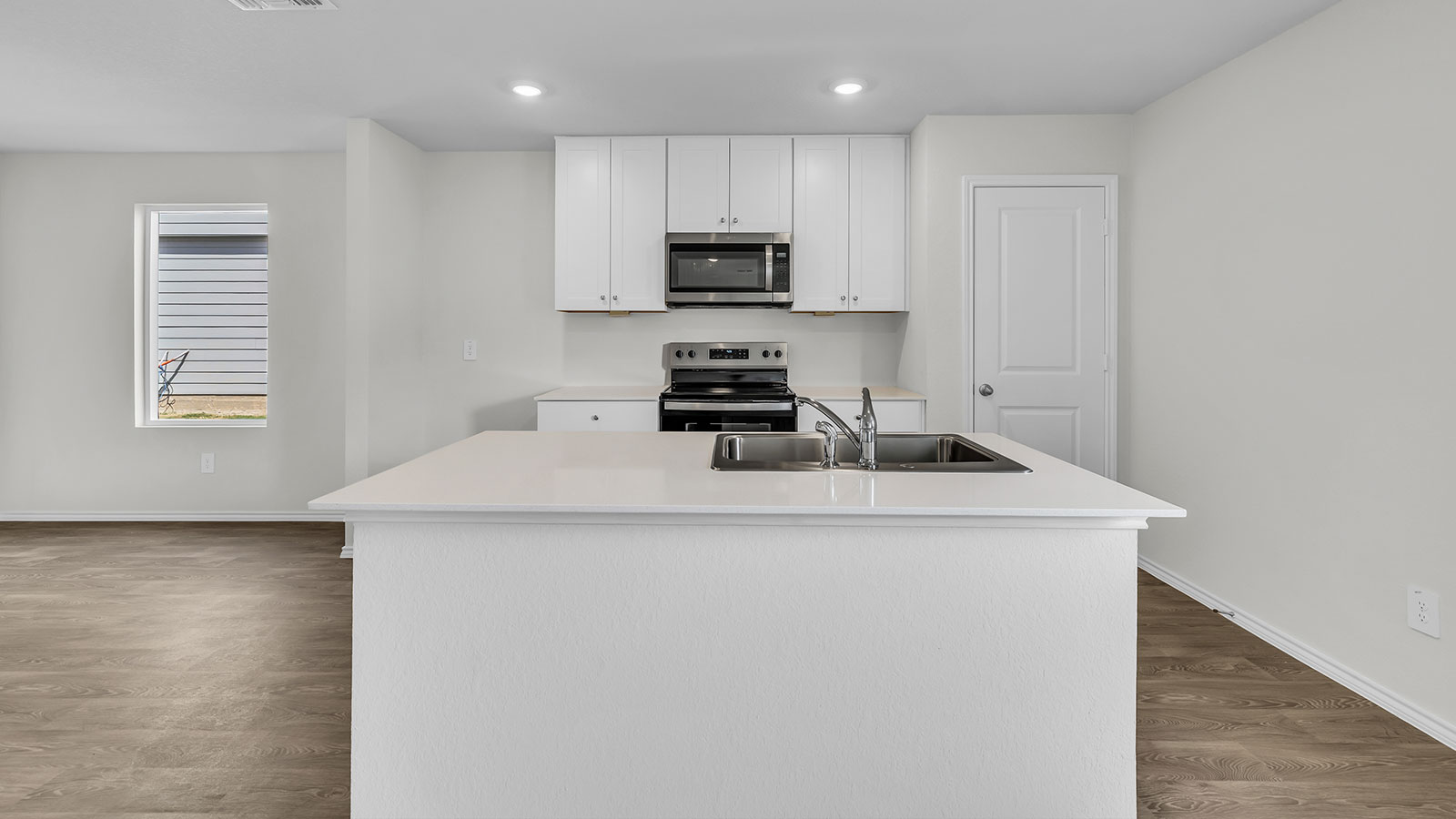 Living room opening to the kitchen and dining room.