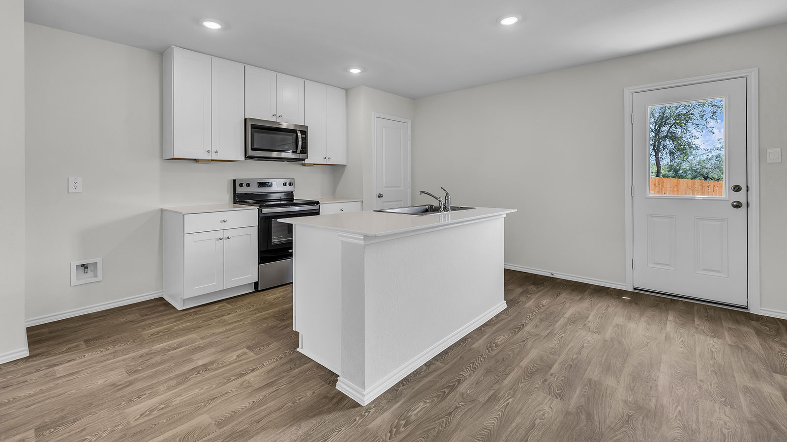 Kitchen with kitchen island and white cabinets.