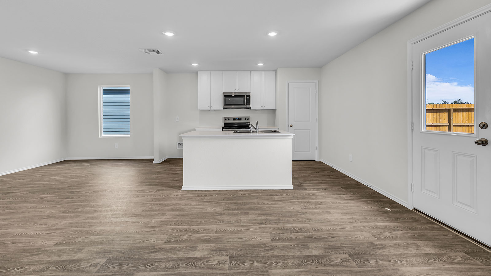 Kitchen with kitchen island and stainless steel appliances.