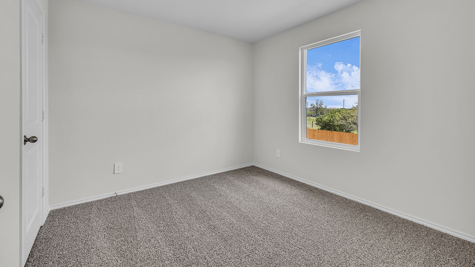Secondary bedroom with carpeting and one window.