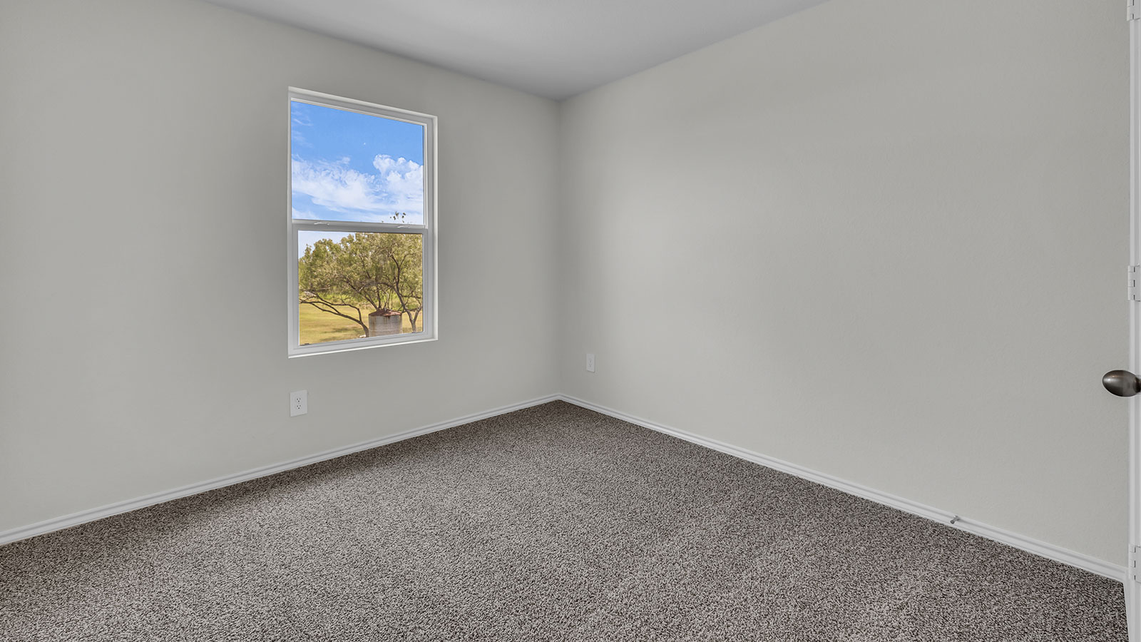 Secondary bedroom with carpeting and one window.