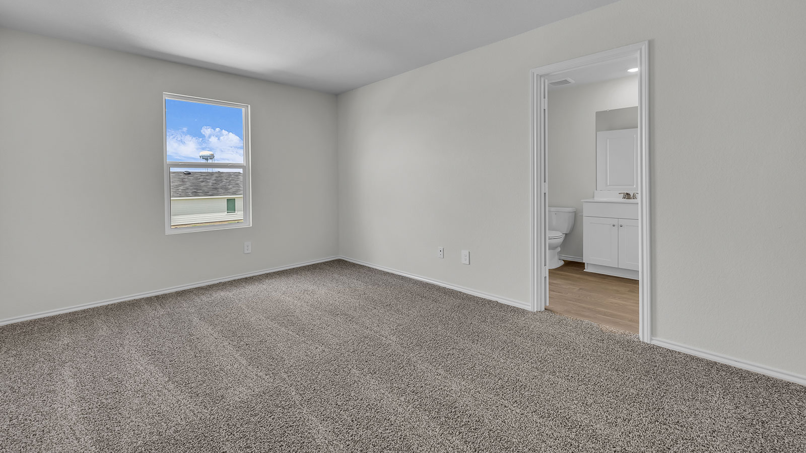 Main bedroom with carpeting and one window.