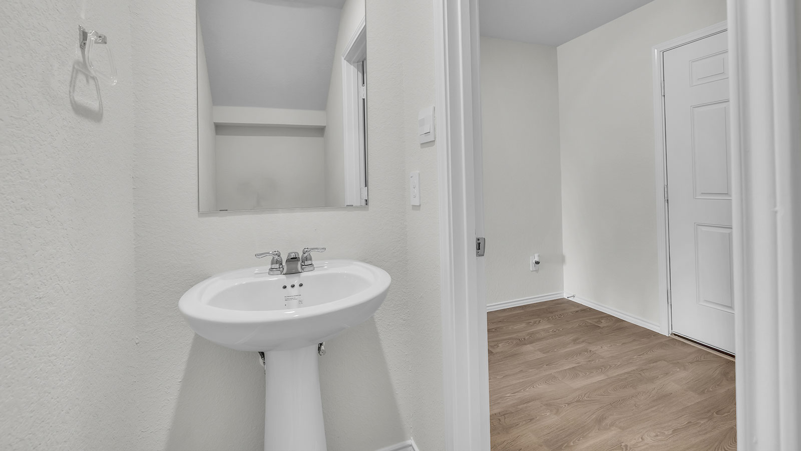 Powder room with a pedestal sink.