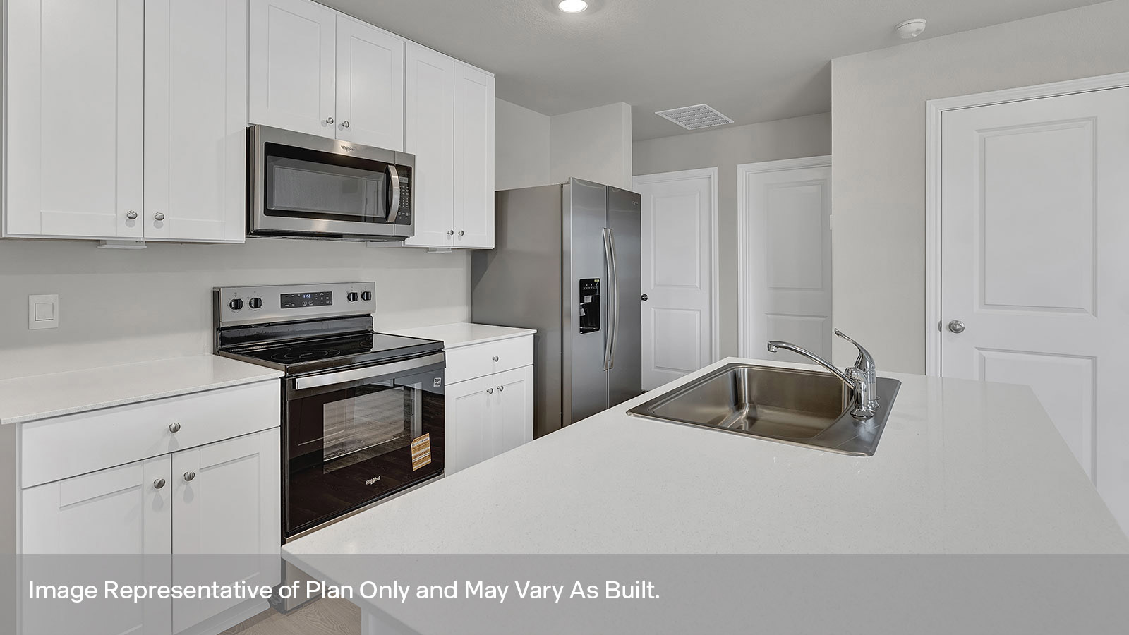 Kitchen with quartz countertops and stainless steel appliances.