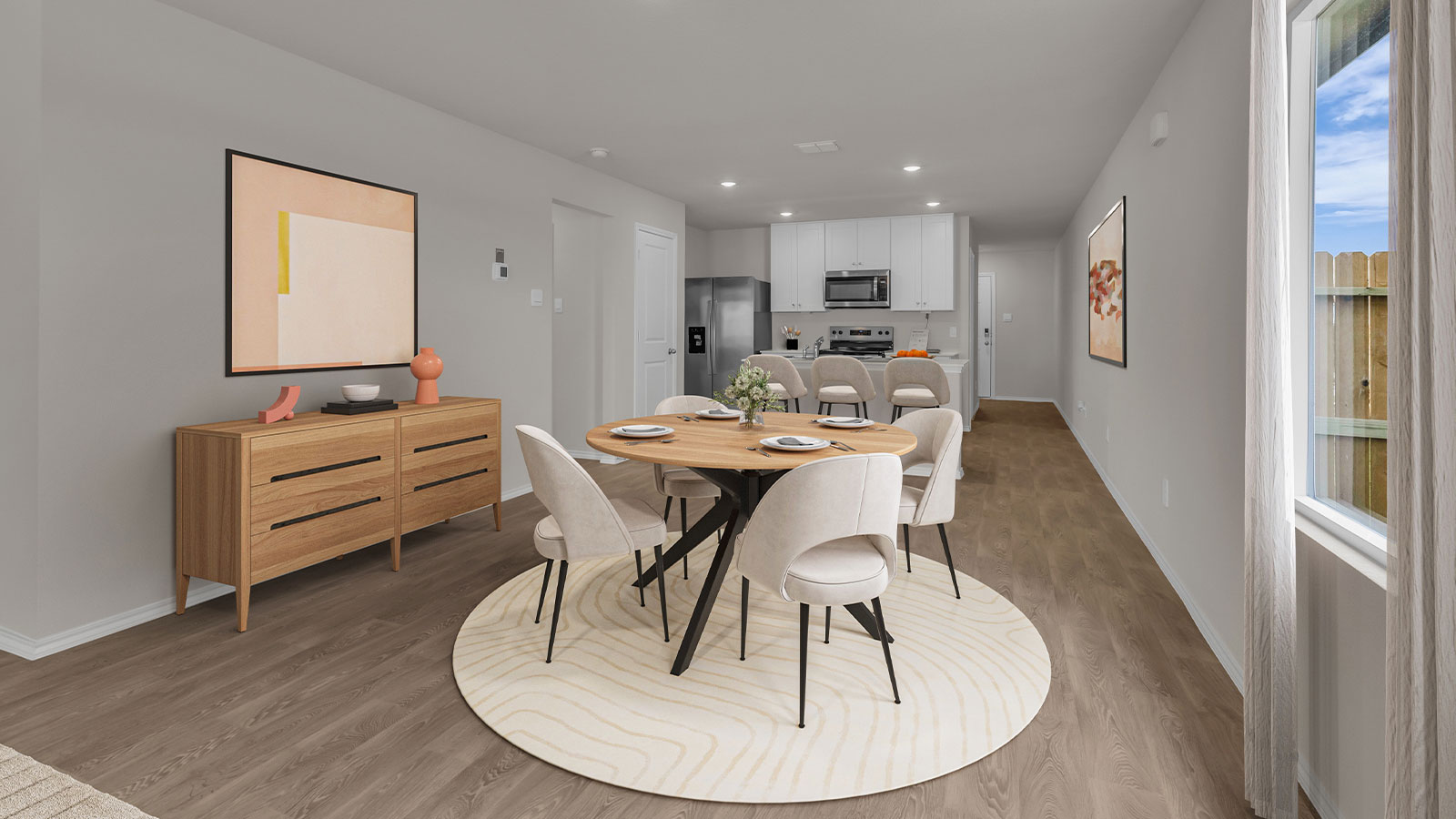 Virtually staged dining room opening to the kitchen.
