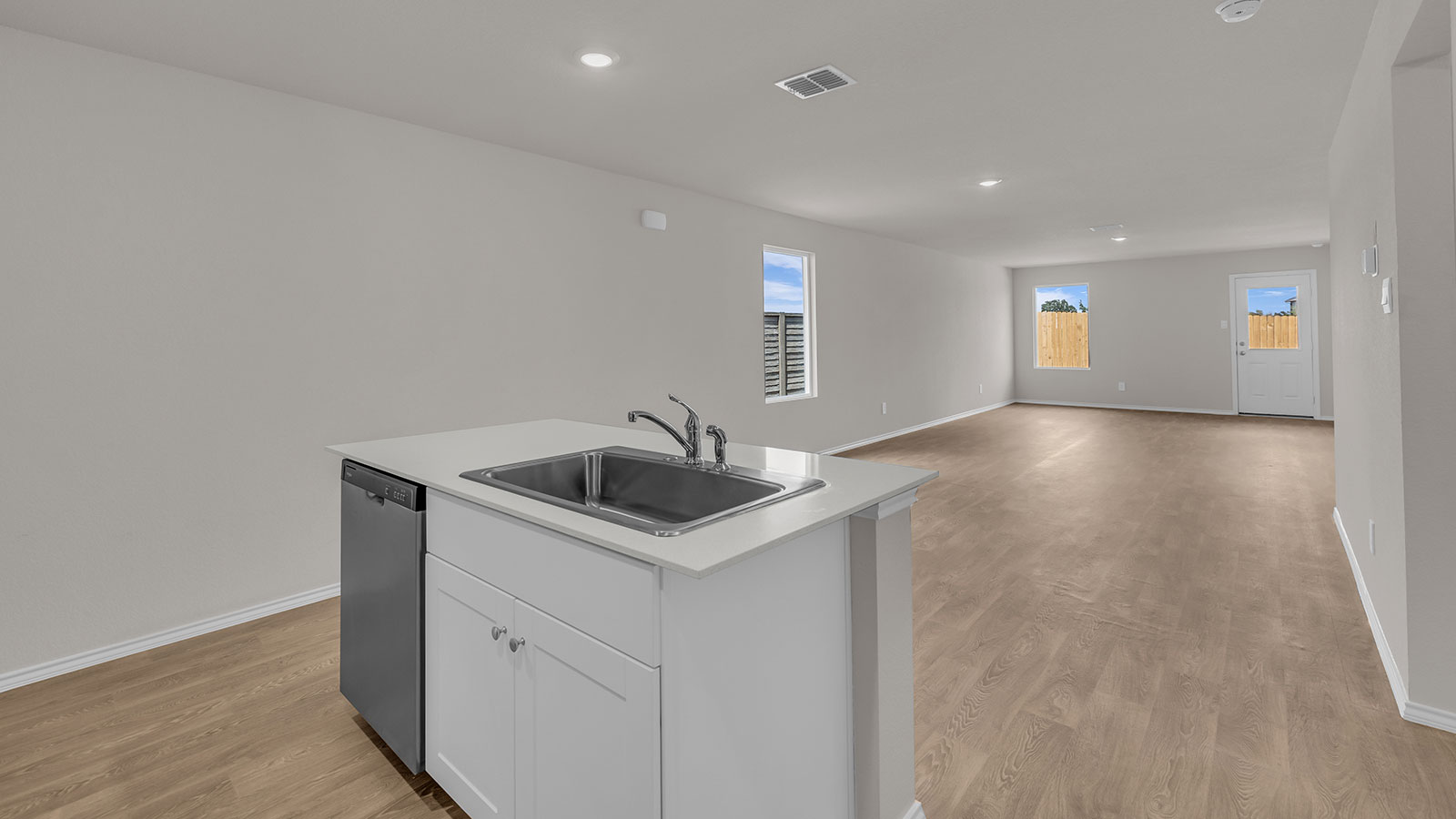 Kitchen with kitchen island and white cabinets.