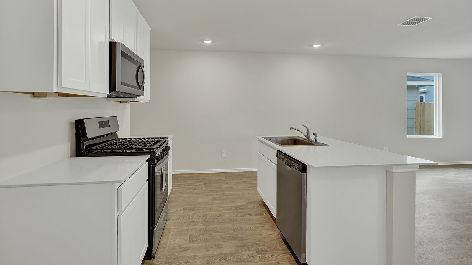 Kitchen with kitchen island and white cabinets.
