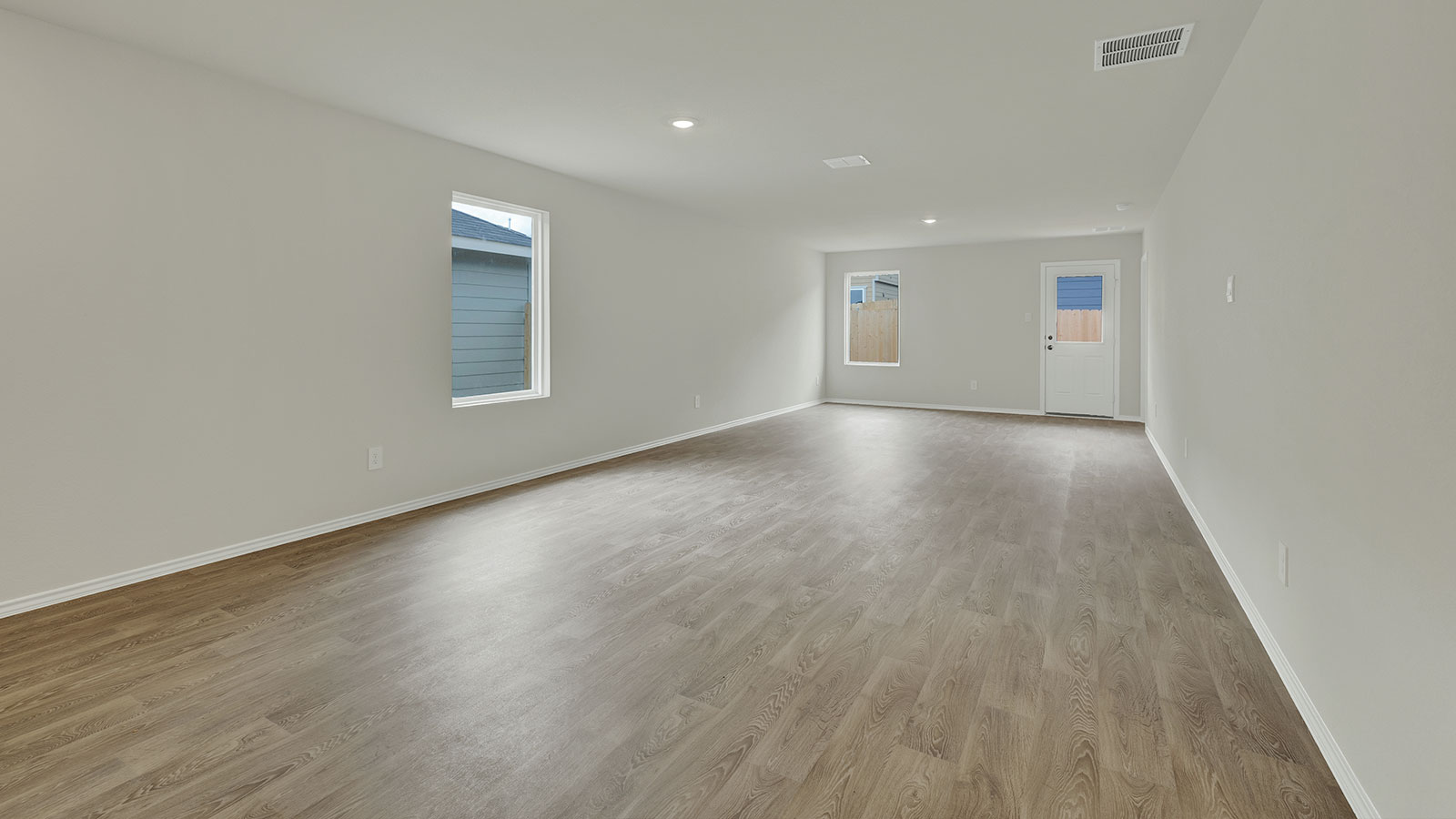 Dining room with vinyl flooring and one window.