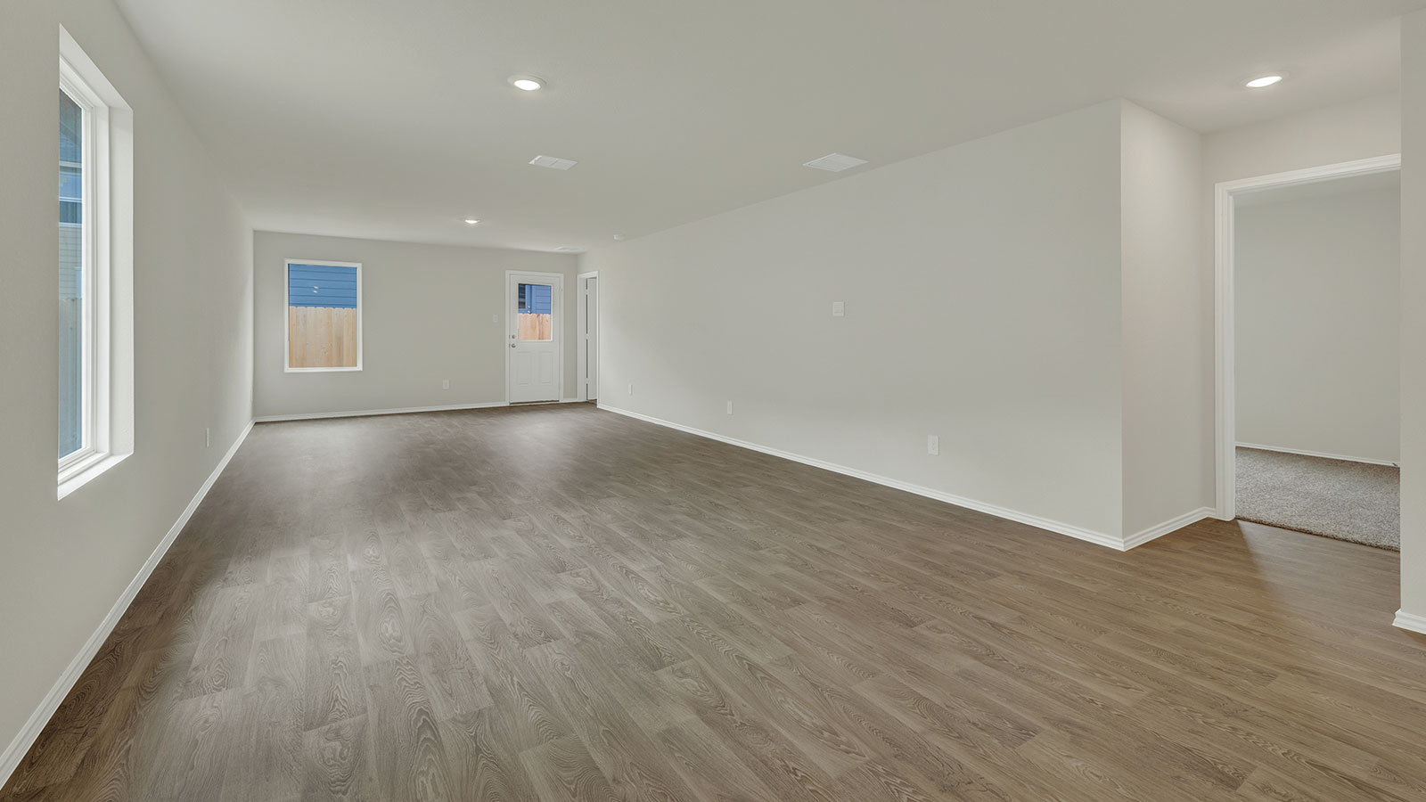 Dining room with vinyl flooring and one window.