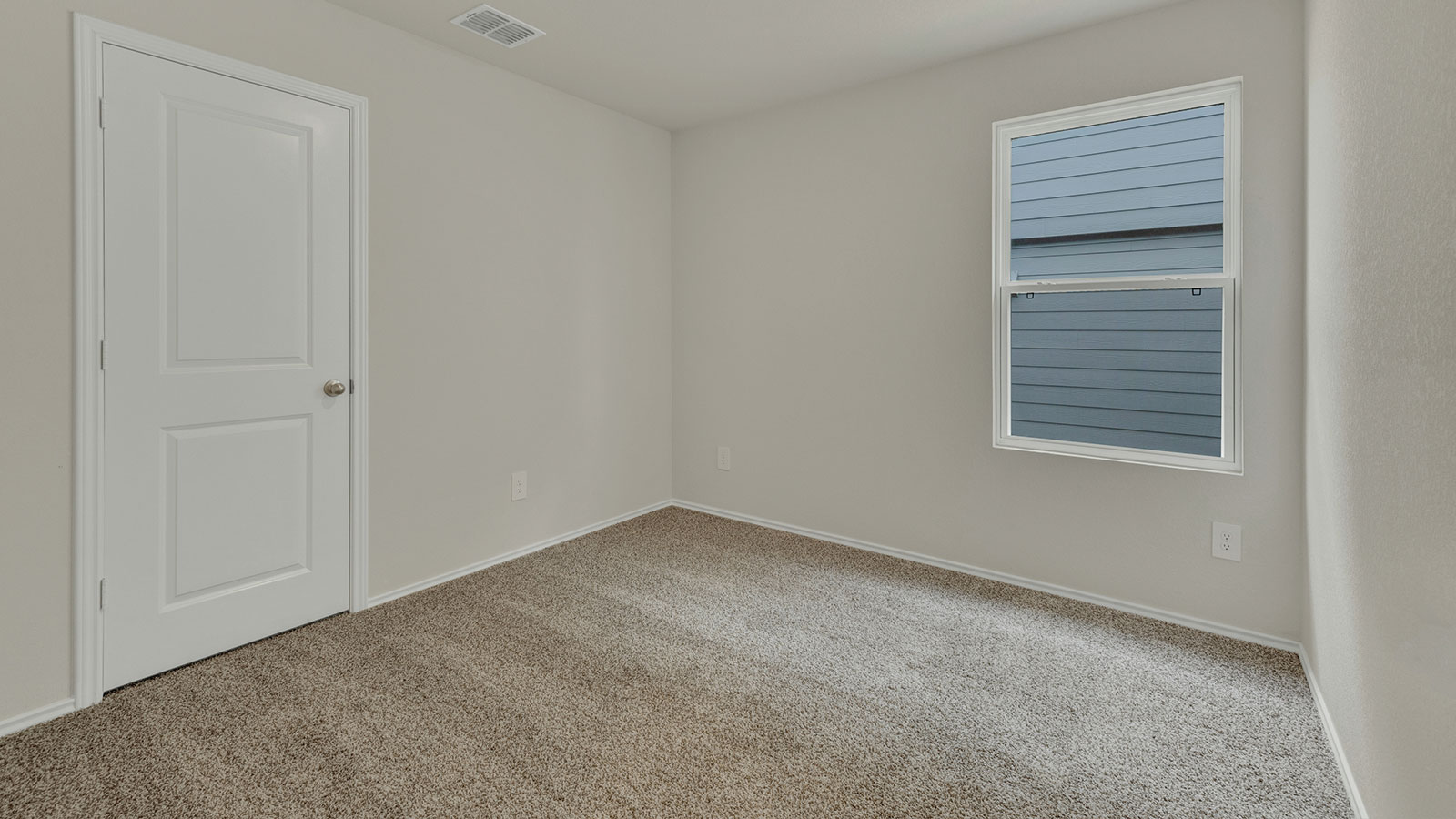 Bedroom with carpeting and one window.