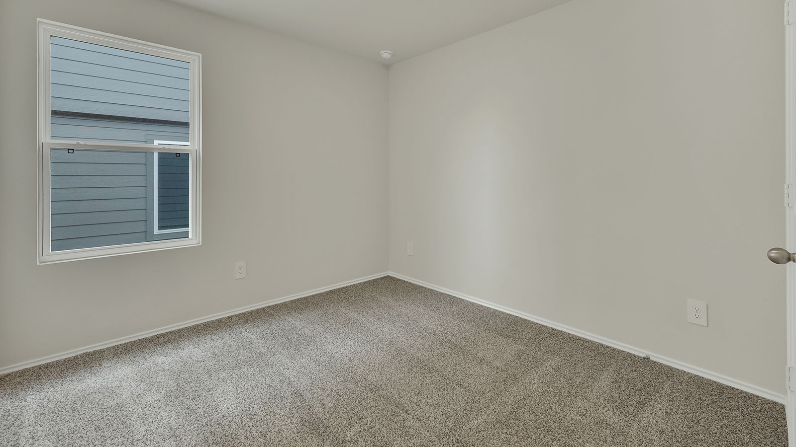 Bedroom with carpeting and one window.
