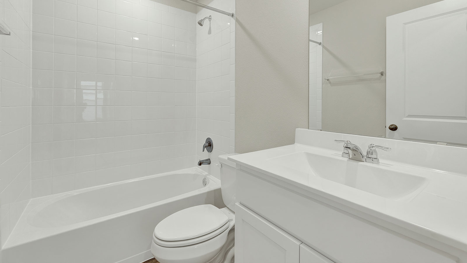 Hall bathroom with single-sink vanity, toilet, and tub.