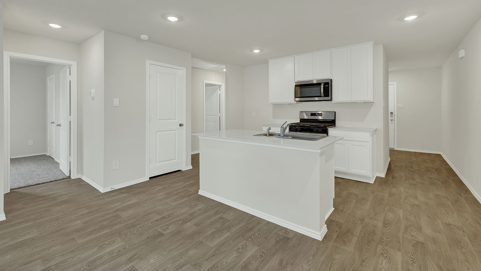 Kitchen with kitchen island and white cabinets.