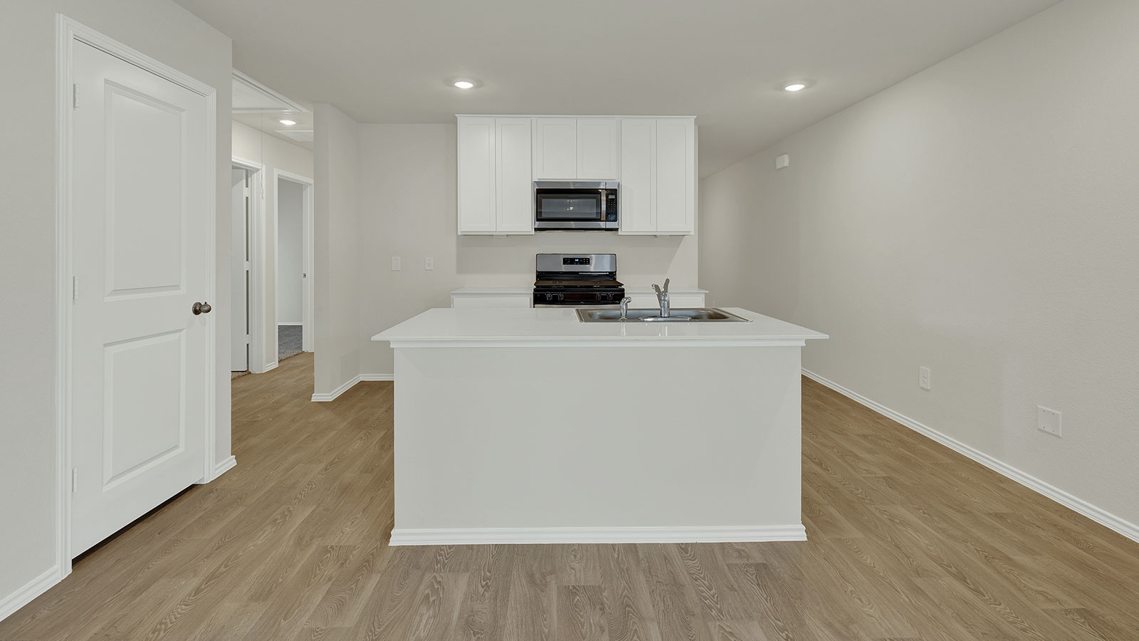 Kitchen with quartz countertops and stainless-steel appliances.