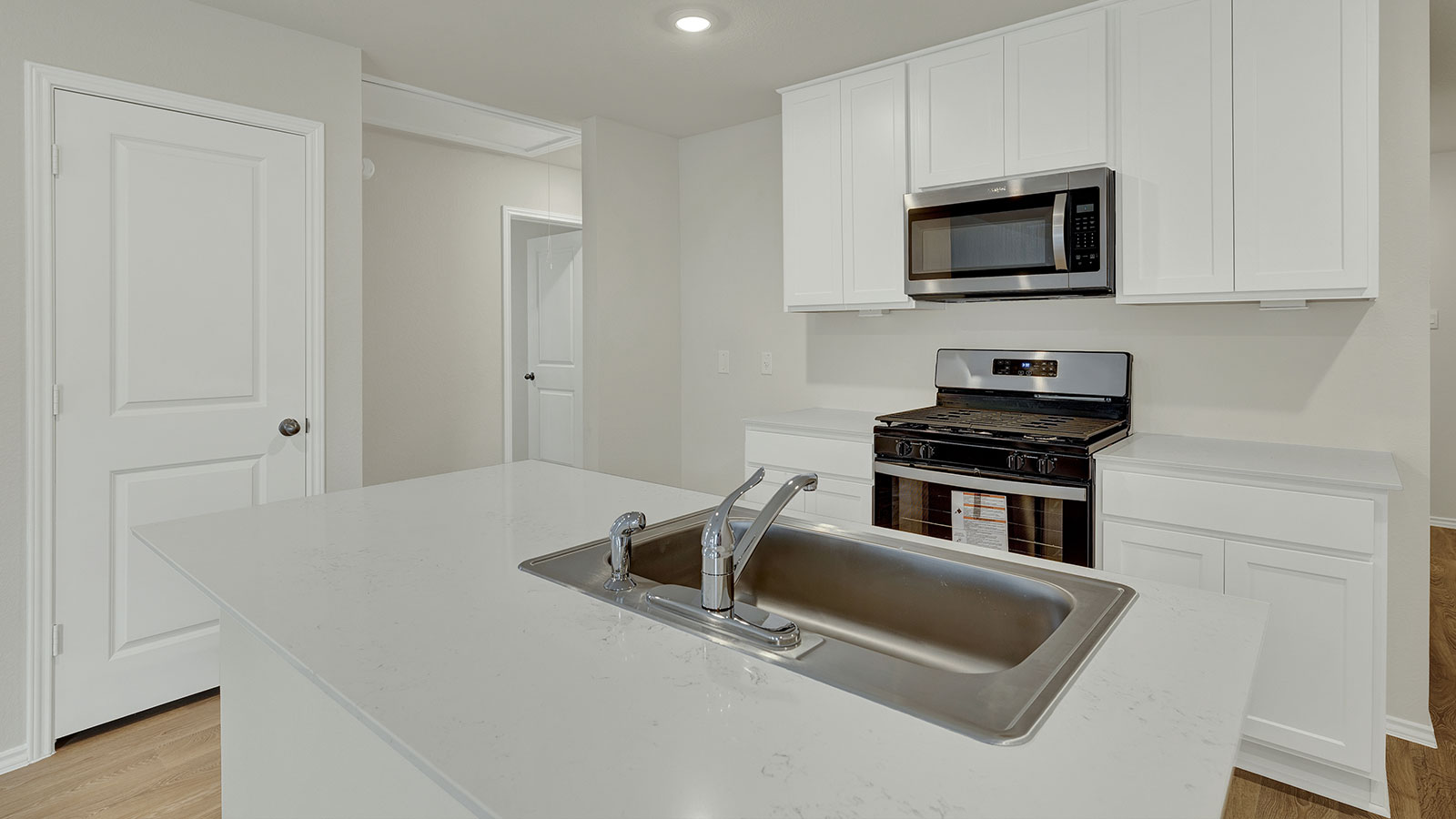 Kitchen with kitchen island and white cabinets.