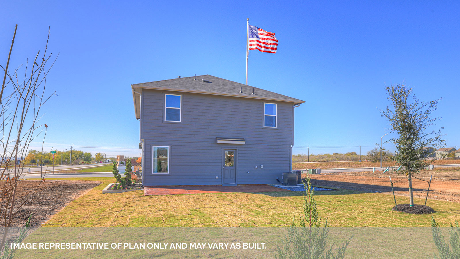 Backyard patio with sod and privacy fence.