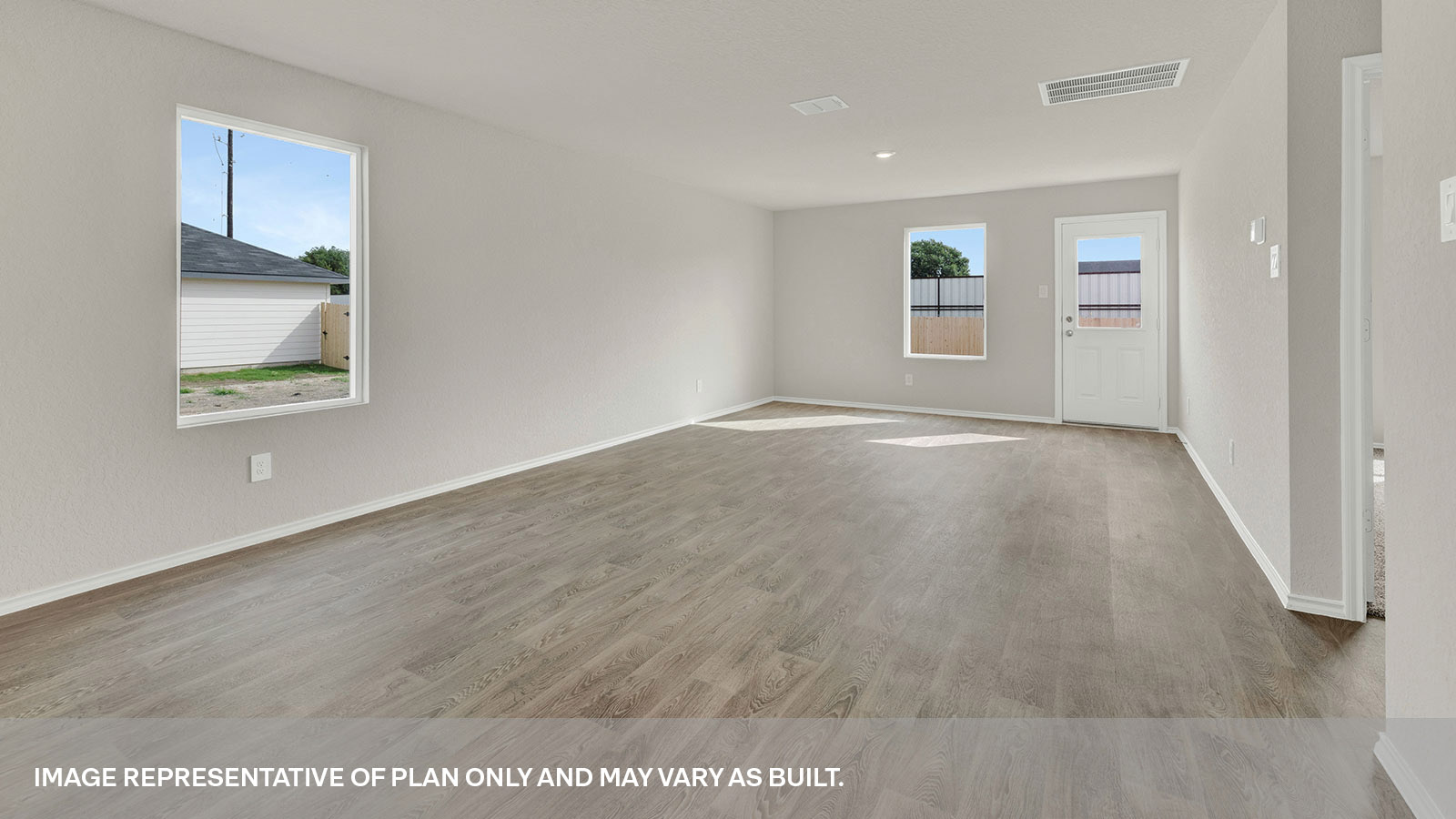 Dining room and living room with vinyl flooring, 2 windows, and a half lite exterior door.