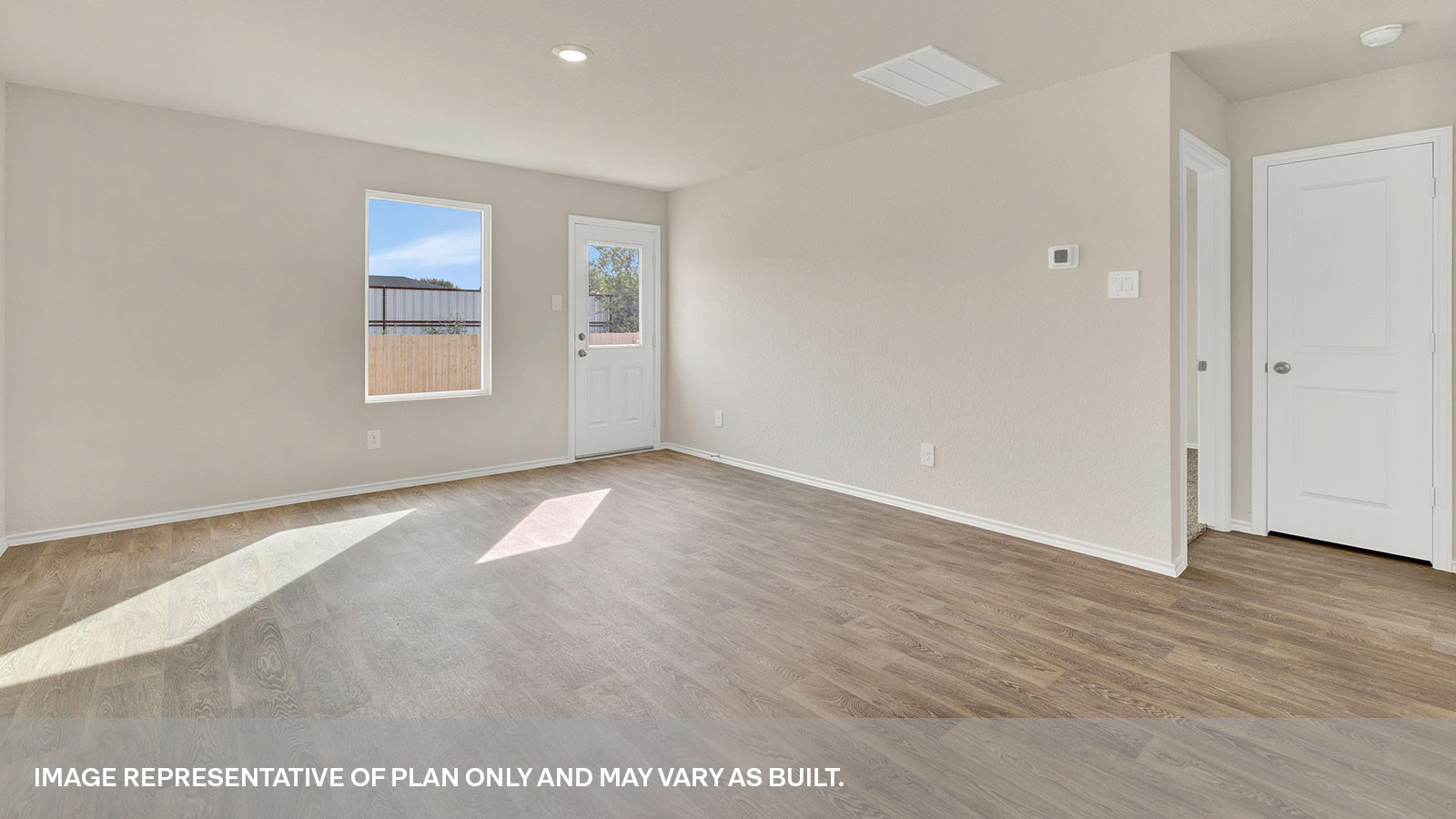 Living room with vinyl flooring, one window, and a half lite exterior door.