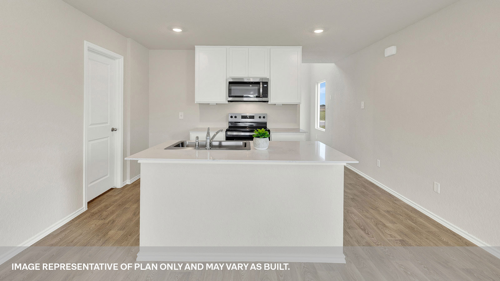 Kitchen with kitchen island and white cabinets.