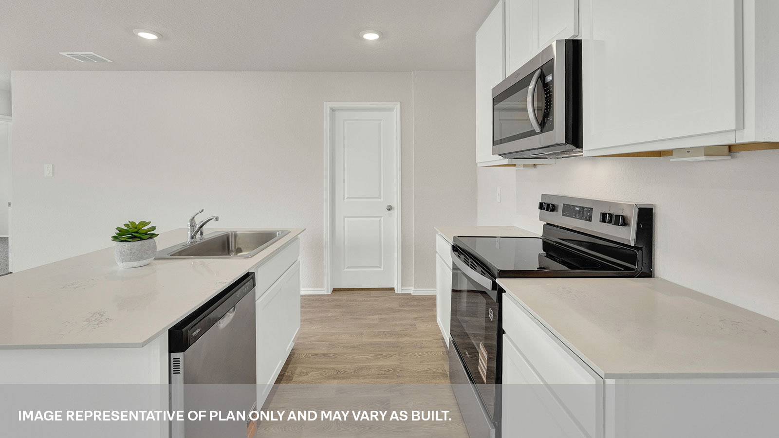 Kitchen with quartz countertops and satinless steel appliances.