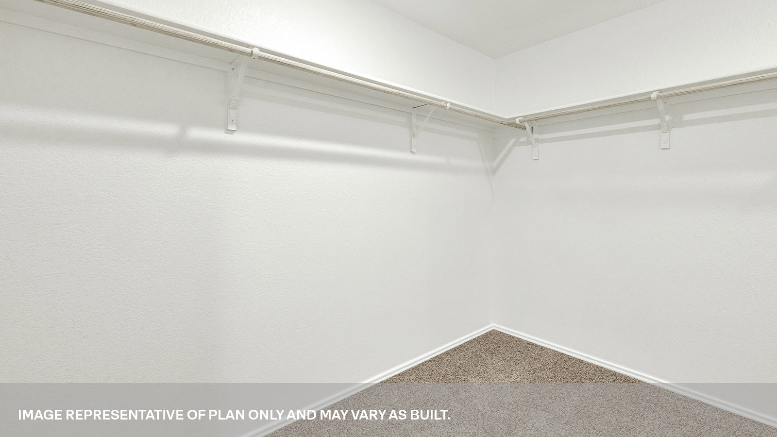 Main bedroom closet with carpeting and wooden shelving.