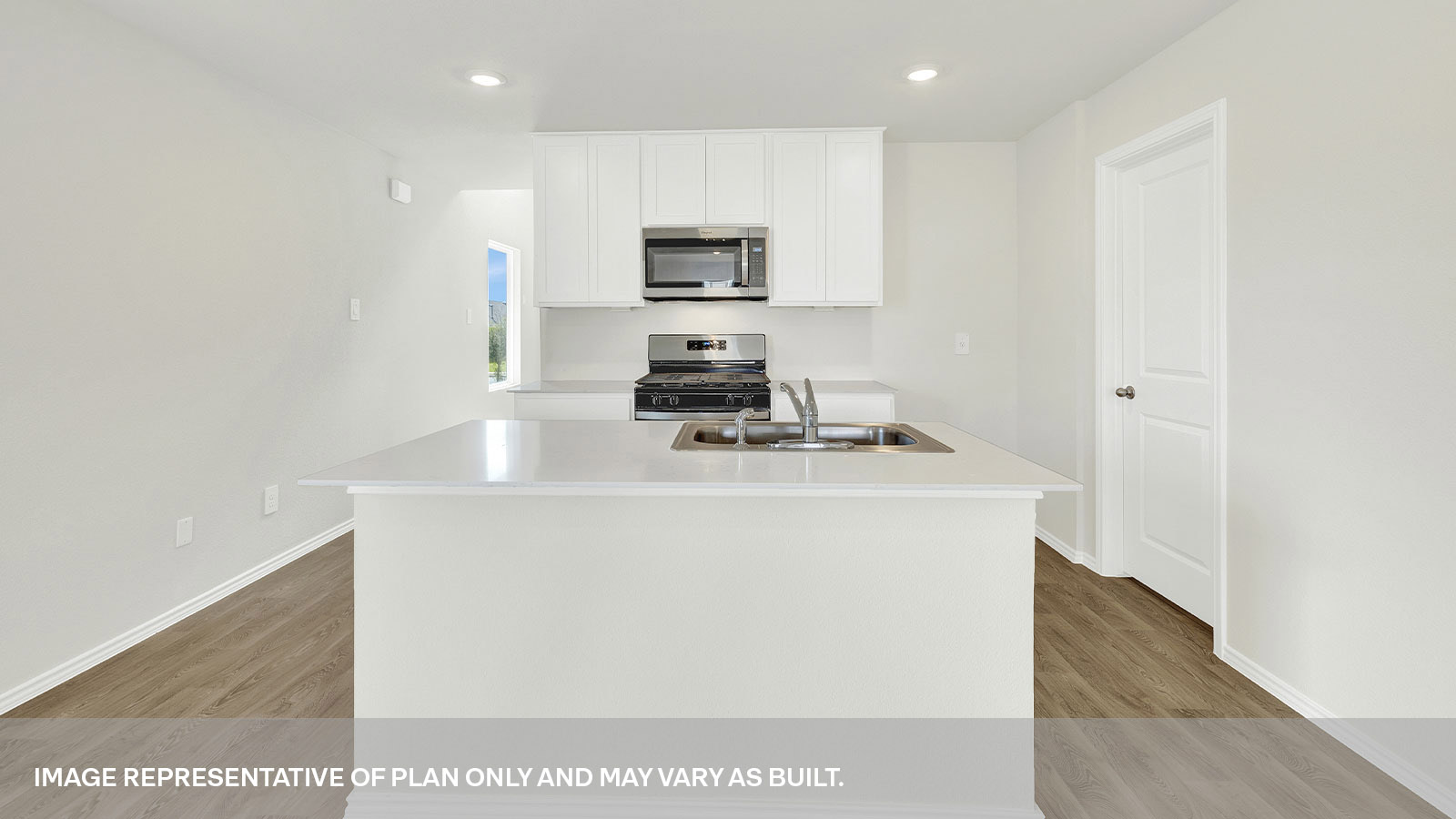 Kitchen with kitchen island and white cabinets.