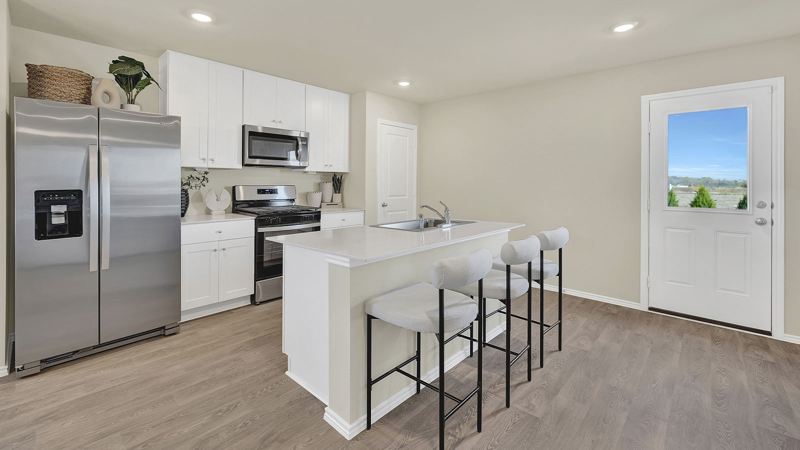 Kitchen with kitchen island and white cabinets.