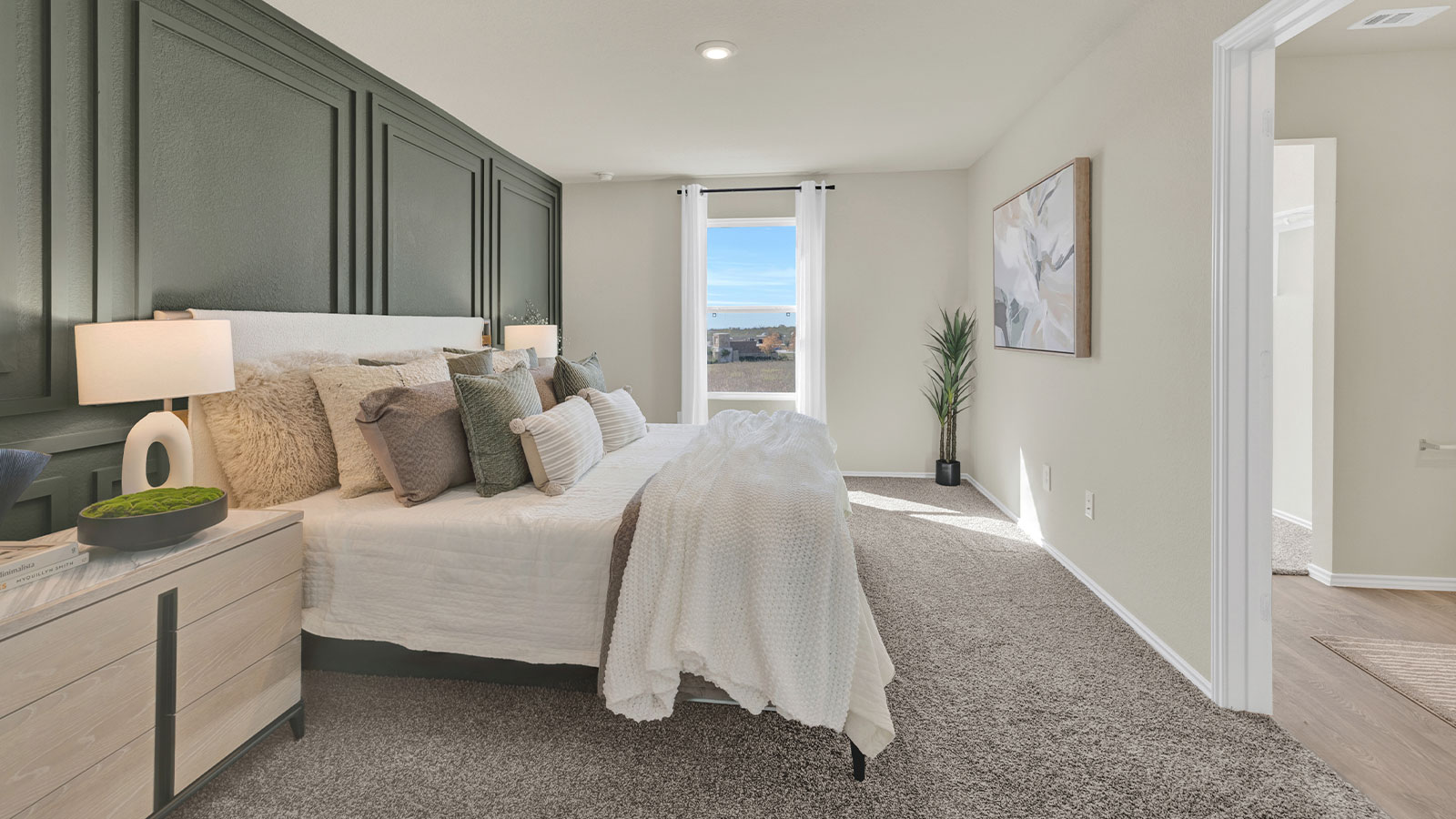 Bedroom with carpeting and one window.