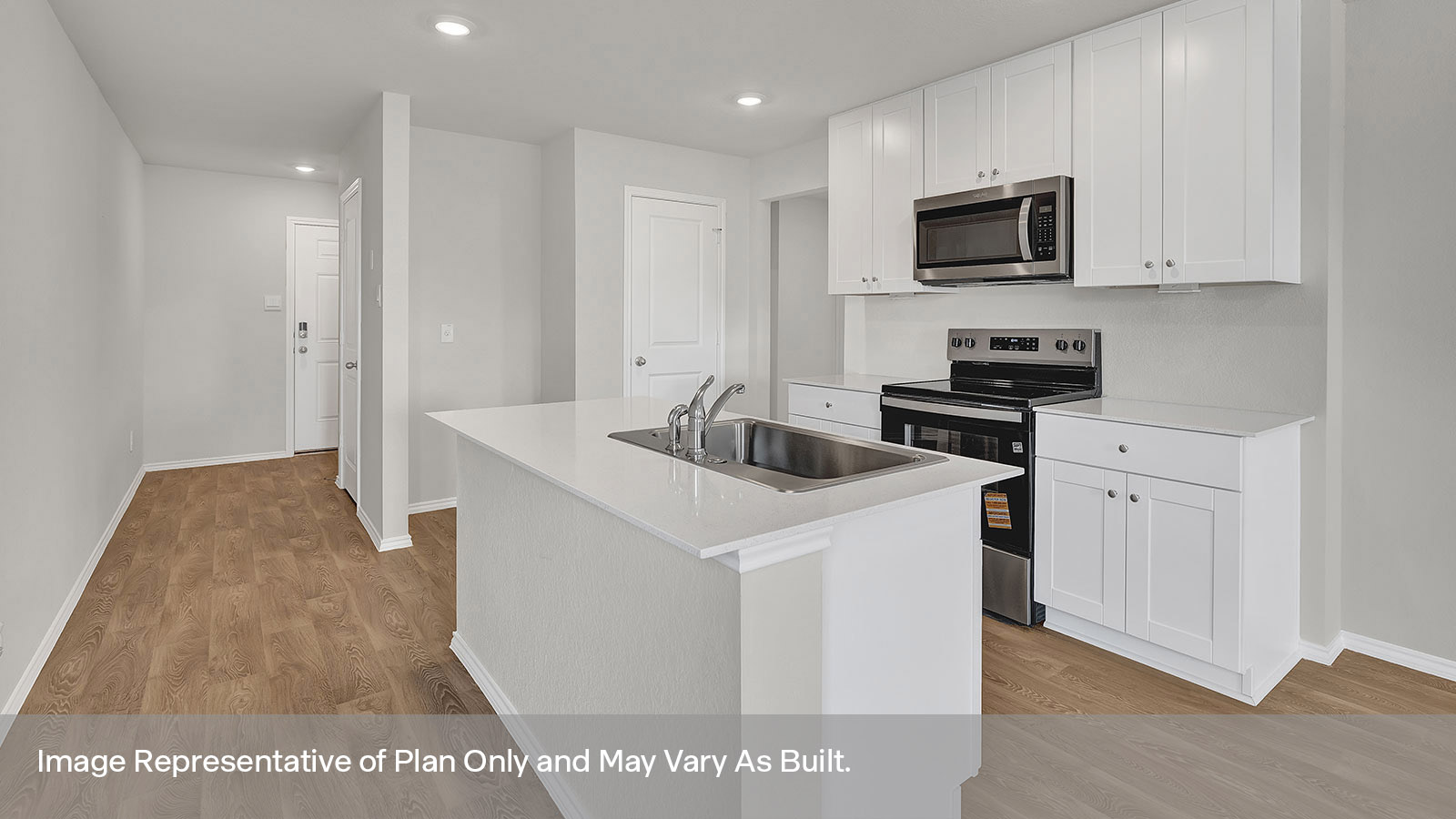 Kitchen with kitchen island and entry hallway.