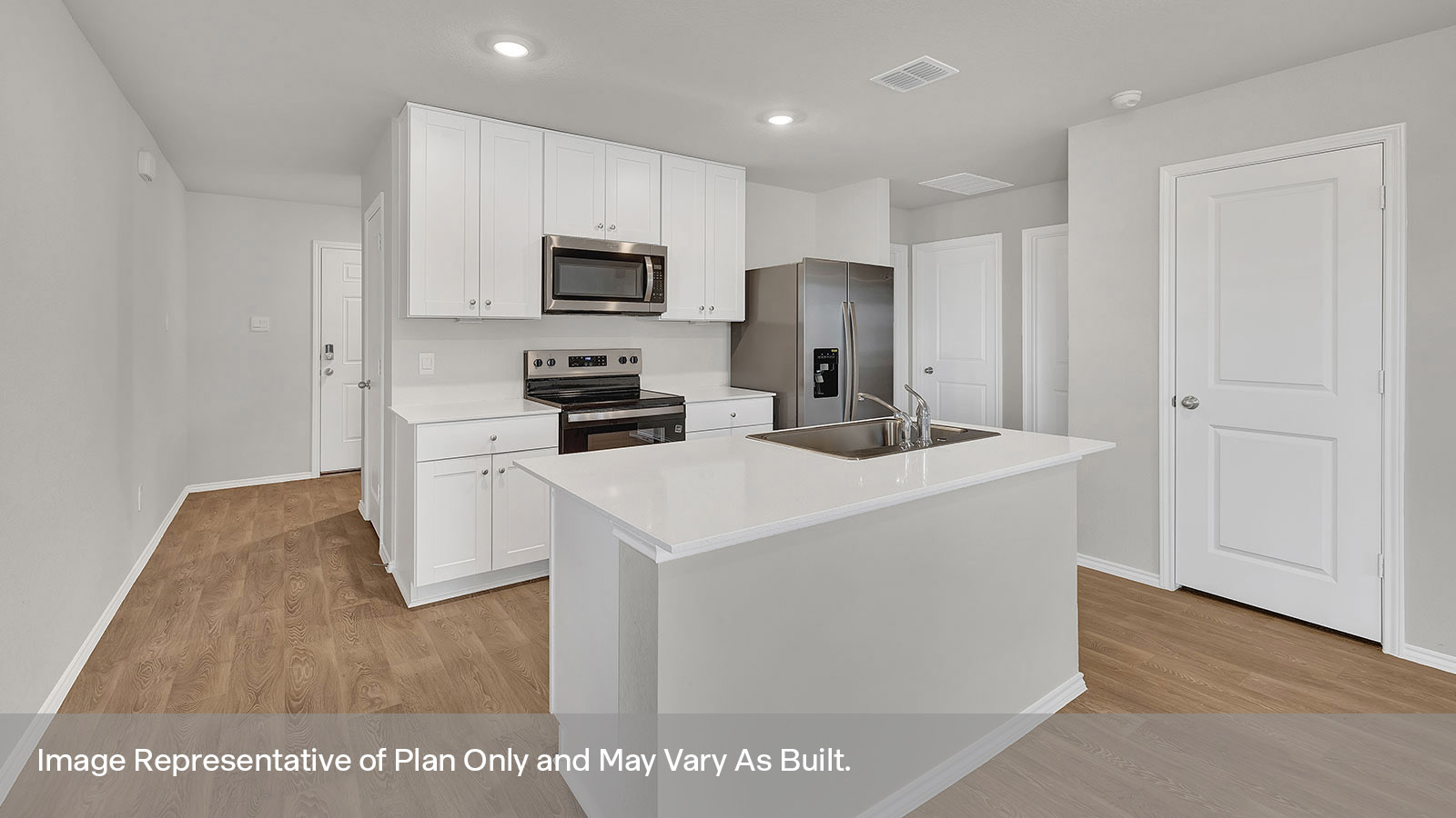 Kitchen with kitchen island and entry hallway.